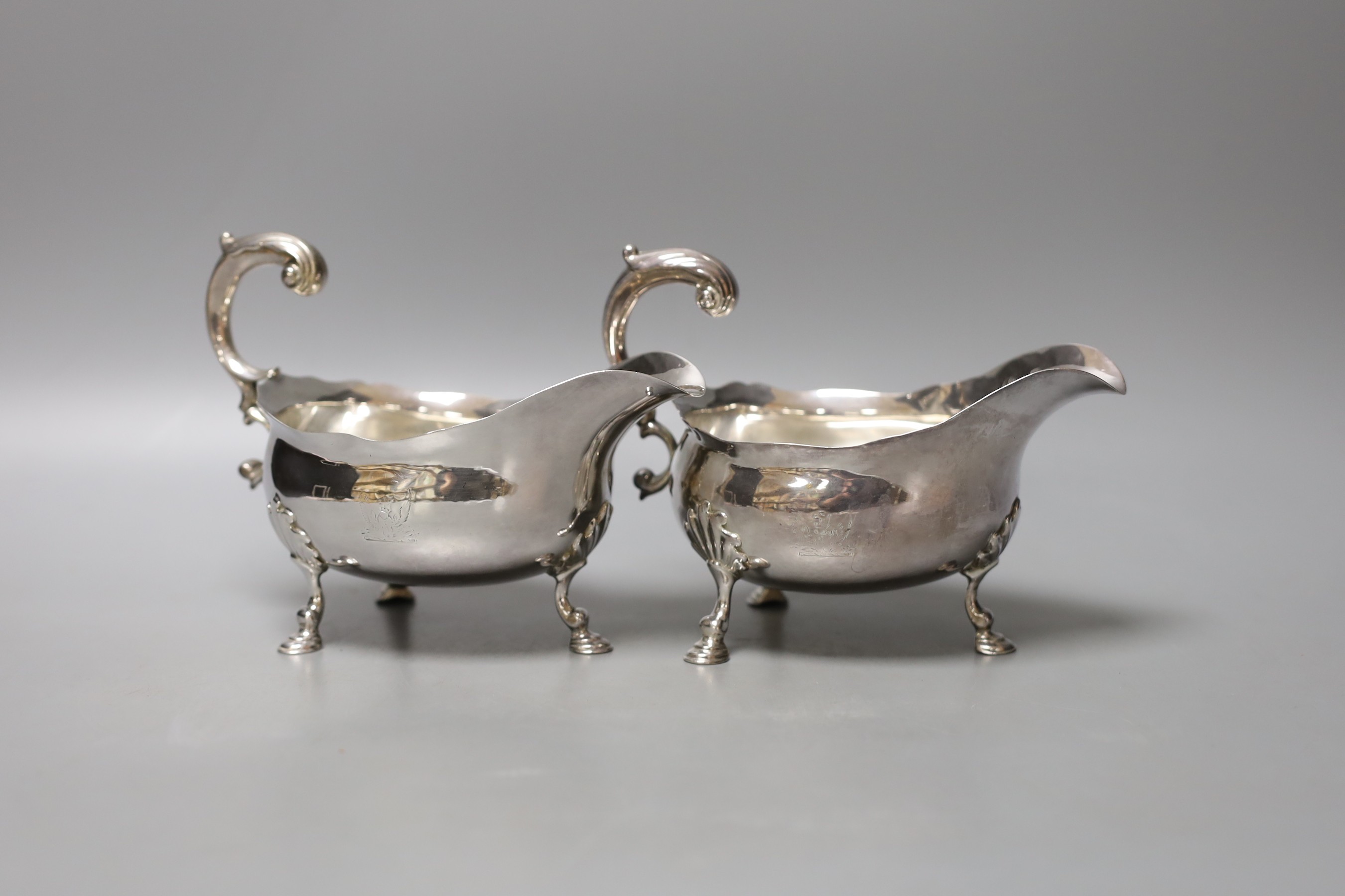 A pair of George II silver sauceboats, with flying scroll handles, maker's mark rubbed, London, 1752, height 12.8cm, 16.5oz.